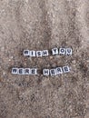 Wish you were here written on sand at the beach Royalty Free Stock Photo