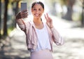 Wishing you all a healthy and safe day. a sporty young woman making a peace sign and taking selfies while exercising Royalty Free Stock Photo