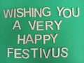 Wishing you a very happy festivus sign on a green background