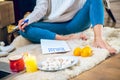 Woman sitting on the floor and prepapring her wishlist