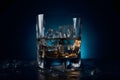 Wiskey beverage in glass with ice cubes on deep blue background