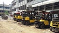 A collection of old forklifts that are parked in a warehouse area that is old and not maintained