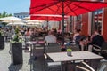 Wismar, Germany, June 15, 2020: People are enjoying the sunny summer day in a street cafe onthe market place after lock down Royalty Free Stock Photo