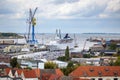 Wismar, Germany Ã¢â¬â September 28, 2019: Wismar sea port with ferry, sail boats and crane from above under a cloudy sky, aerial