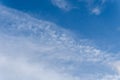 Wispy Cirrus Clouds in a Bright Blue Sky Background Royalty Free Stock Photo
