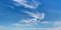 Wispy cirrus clouds high in the blue sky. Uncinus and fibratus subforms of cirrus clouds Royalty Free Stock Photo