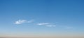 Wispy long strand clouds float across blue sky panorama Royalty Free Stock Photo