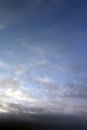 Wispy, translucent clouds against a darkening blue sky just before sunset. Suitable for abstract forms can be used as backgrounds. Royalty Free Stock Photo