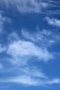 Wispy white clouds against a blue sky