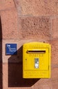 Wissembourg, France. September 13th, 2009. Yellow mailbox on the facade of a building in the historic center of the town