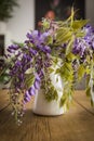 Wisteria inside a jug on a wooden table Royalty Free Stock Photo