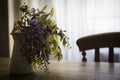 Wisteria inside a jug on a wooden table Royalty Free Stock Photo