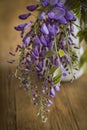 Wisteria inside a jug on a wooden table Royalty Free Stock Photo