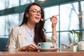 Wistful elegant woman eating desert Royalty Free Stock Photo