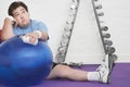 Wistful Overweight Man On Floor With Exercise Ball Royalty Free Stock Photo