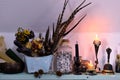 Witch altar with burning candles, dry herbs and feathers Royalty Free Stock Photo