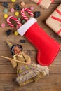 The witch Befana and red stocking with sweet coal and candy on rustic wooden background. Italian Epiphany day tradition Royalty Free Stock Photo