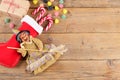 The witch Befana and red stocking with sweet coal and candy on rustic wooden background. Italian Epiphany day tradition Royalty Free Stock Photo