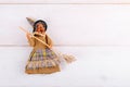 The witch Befana on white wooden background, top view, copy space