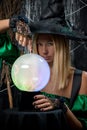 witch on a black background with a magic ball Royalty Free Stock Photo