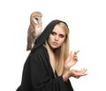 Witch in black mantle with owl isolated on white. Scary fantasy character
