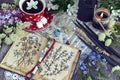 Witch book with magic and healing herbs, black candles and cup of tea Royalty Free Stock Photo