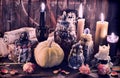 Witch bottles with pumpkin, black candles and paper scrolls