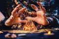 A witch conjures a magic glass pyramid. Hands close-up. Sparks flare up near the pyramid. The concept of witchcraft and Royalty Free Stock Photo