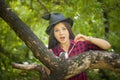 Witch conjures in the woods with a familiar. Brunette girl with a Royalty Free Stock Photo