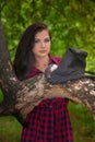 Witch conjures in the woods with a familiar. Brunette girl with a Royalty Free Stock Photo