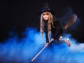 Witch flying on broomstick.