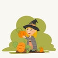 The witch girl in a black hat harvests an autumn crop of large ripe orange pumpkins