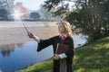 Witch girl with magic wand cosplay Harry Potter wizzard outdoor. Halloween holiday. Halloween costume. Royalty Free Stock Photo