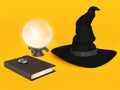 Witch hat, spell book and crystal ball.