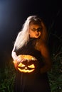 Witch holding a Jack pumpkin in her hands Royalty Free Stock Photo