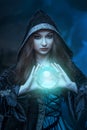 The witch with magic ball in her hands causes a spirits Royalty Free Stock Photo