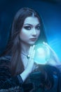 The witch with magic ball in her hands causes a spirits Royalty Free Stock Photo