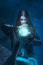 The witch with magic ball in her hands causes a spirits Royalty Free Stock Photo