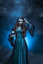 The witch with magic ball in her hands causes a spirits Royalty Free Stock Photo