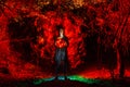 Witch playing with red lights in the dark forest Royalty Free Stock Photo