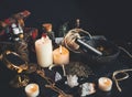 Witch`s working space. A very messy witch`s altar filled with random tidbits like mortar and pestle, burning white candles Royalty Free Stock Photo