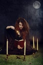 Witch with wand casting a spell at night Royalty Free Stock Photo