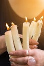 witchcraft rite with white candles in the hands of a witch woman