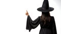 Witching Hour at Halloween, witch pointing at white copy space. Generative AI Royalty Free Stock Photo