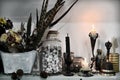 Witch ritual objects and black candles on shelf Royalty Free Stock Photo