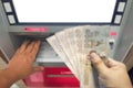 Withdraw bank notes in the hand of five thousand baht from the ATM