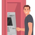 Withdrawing money on atm concept. Young man standing entering pincode on atm machine for getting money cash Royalty Free Stock Photo