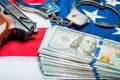 Withdrawn money and weapons on the American flag - a crime and punishment concept Royalty Free Stock Photo