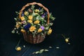 Withered roses with fallen leaves on a wooden black background. Wicker basket with dry yellow and blue flowers. Autumn composition Royalty Free Stock Photo