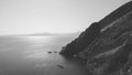 Monochromatic image of breathtaking Mediterranean beauty sea meeting mountain cliffs